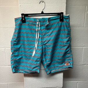 Vibrant Teal and Orange Wave Board Shorts